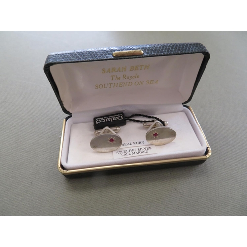 43 - Pair of Sterling Silver and ruby cufflinks boxed