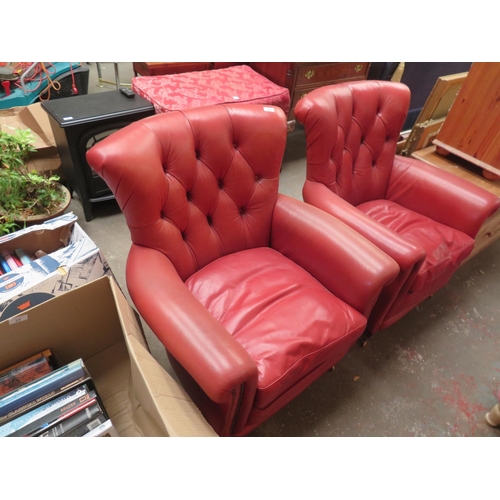 25 - A pair of red leather button back armchair