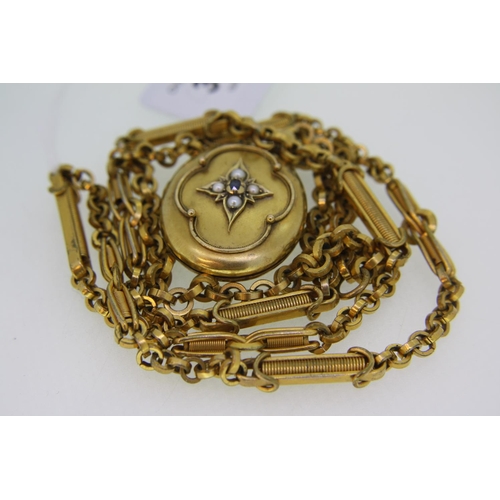 301 - A gilt metal locket with seed pearl decoration on a fancy long gilt metal chain