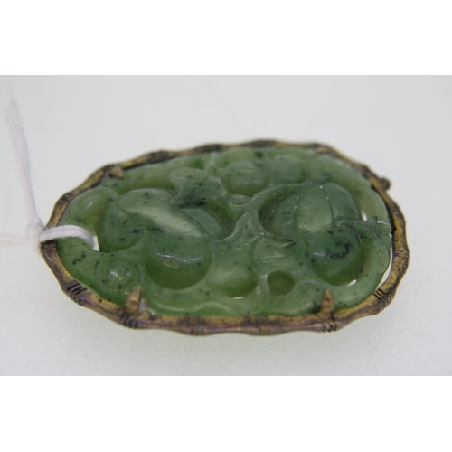 317 - A Chinese Jade carved pendant with decoration of fruit and bat