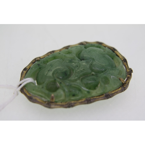 317 - A Chinese Jade carved pendant with decoration of fruit and bat