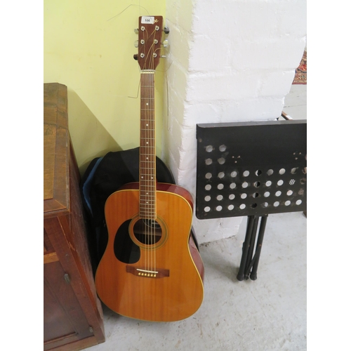 106 - Vintage left handed acoustic guitar with soft case and a music stand