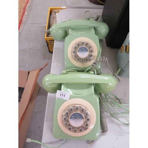 111 - Two green plastic telephones