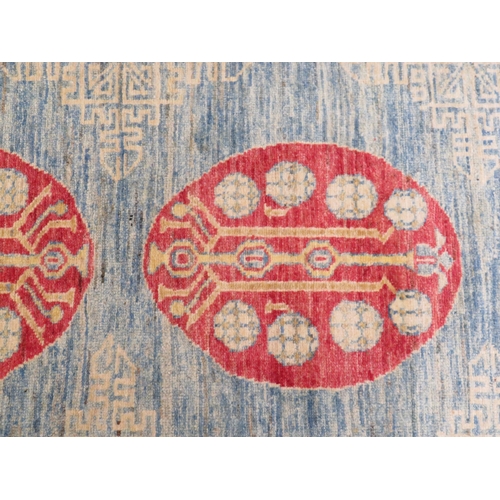 83 - Good quality Samarkand rug in mostly blue red and cream wools, geometric designs, 81x59ins approx