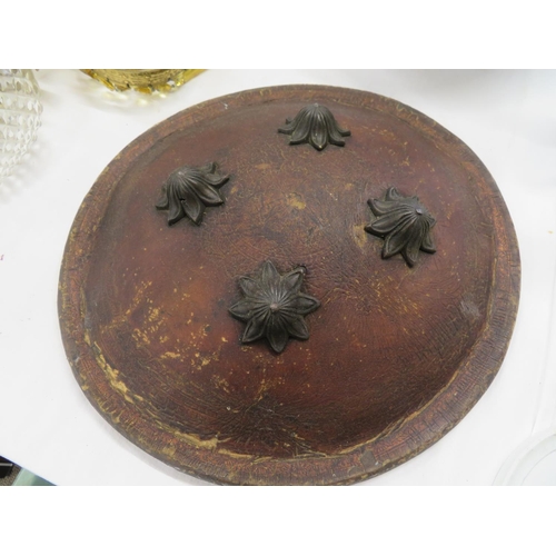 50 - Indian circular leather shield with fluted brass studs to decorate