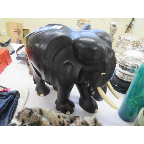 60 - Ebony carved elephant with bone tusks and toe nails