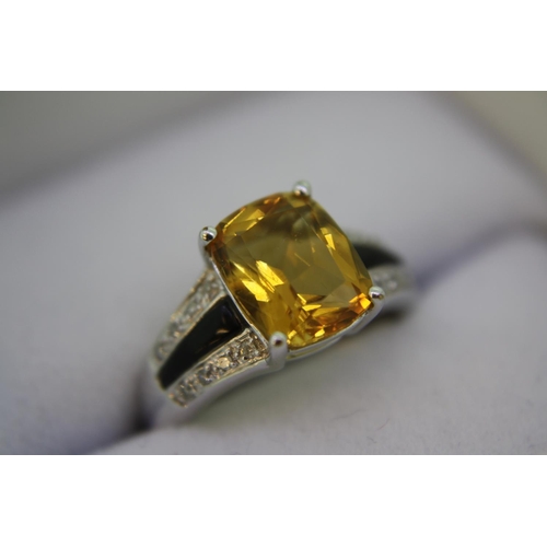 138 - A white gold ring set with cushion cut citrine, black onyx and diamond shoulders - size K/L