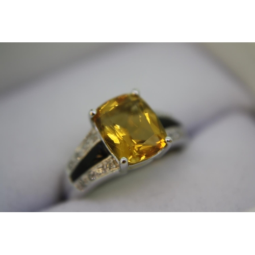 138 - A white gold ring set with cushion cut citrine, black onyx and diamond shoulders - size K/L