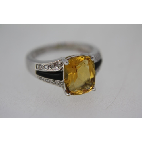 138 - A white gold ring set with cushion cut citrine, black onyx and diamond shoulders - size K/L