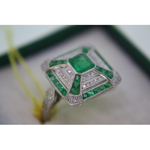 140 - A platinum emerald and diamond square ring in the art deco stye with diamond shoulders - size N/O