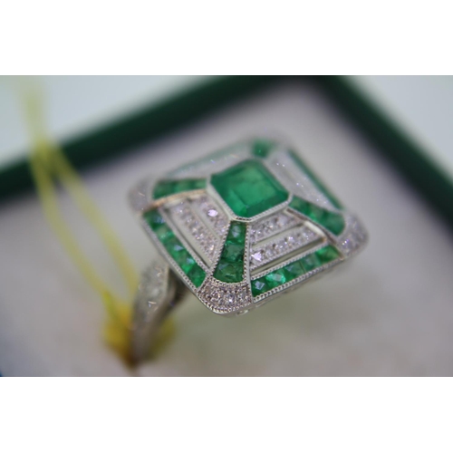 140 - A platinum emerald and diamond square ring in the art deco stye with diamond shoulders - size N/O