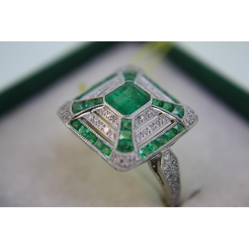 140 - A platinum emerald and diamond square ring in the art deco stye with diamond shoulders - size N/O