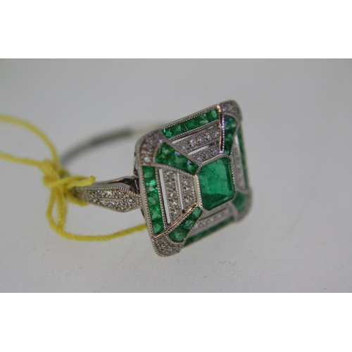 140 - A platinum emerald and diamond square ring in the art deco stye with diamond shoulders - size N/O