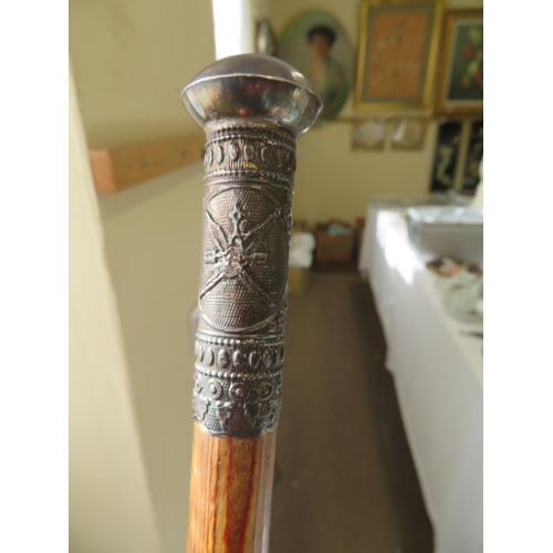 150 - A ladies' walking cane with a silver metal top