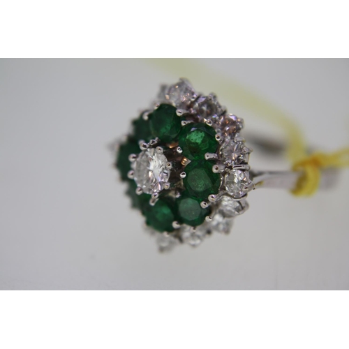 201 - 18 ct. white gold emerald and diamond cluster ring, size O