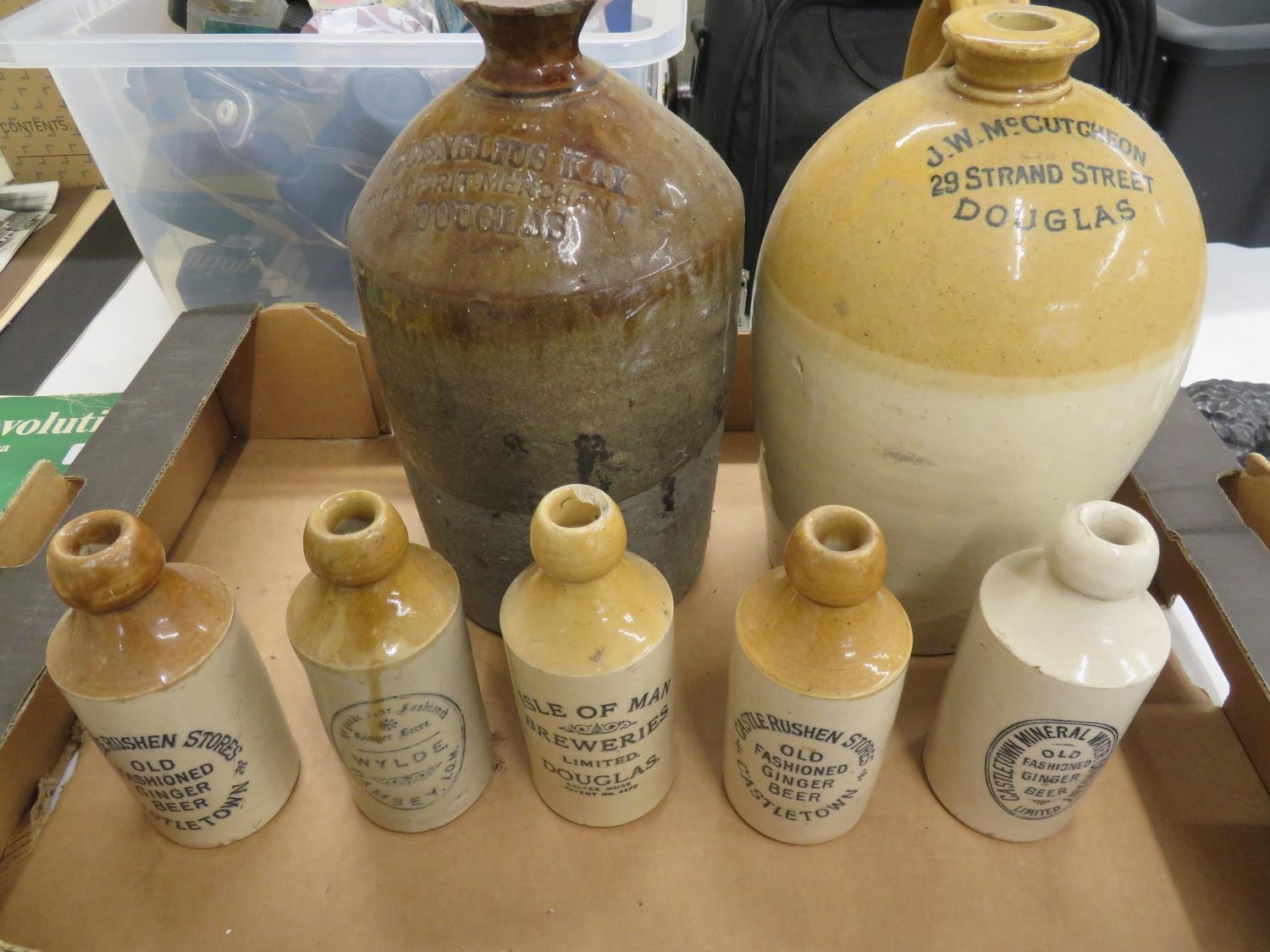 Seven Isle of Man stoneware ginger beer bottles all named