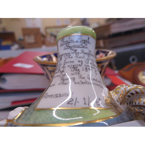 31 - Two Royal Crown Derby squat figures of men advertising events on their hats, one damaged