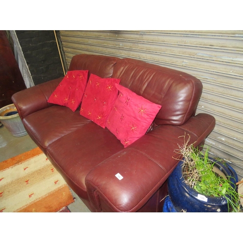 126 - Burgundy leather two seater settee