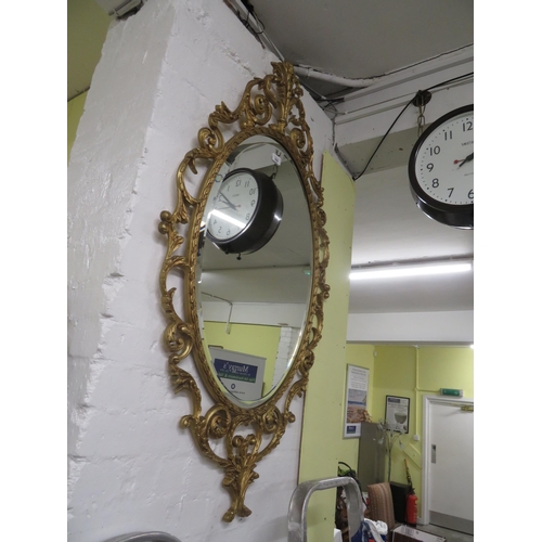 302 - Cast metal framed oval bevel edged glass wall mirror