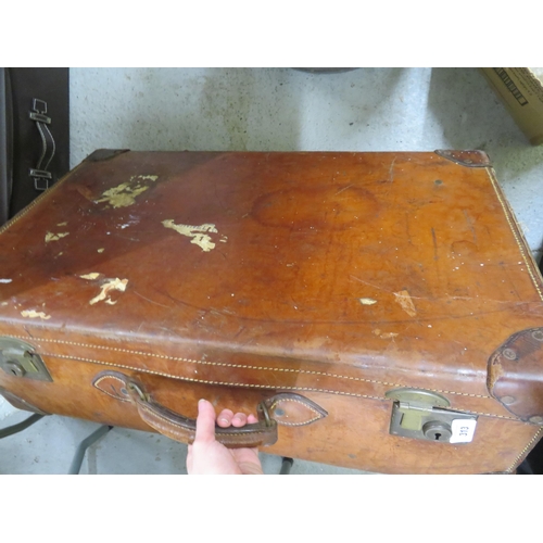 313 - Large brown leather suitcase with brass fittings