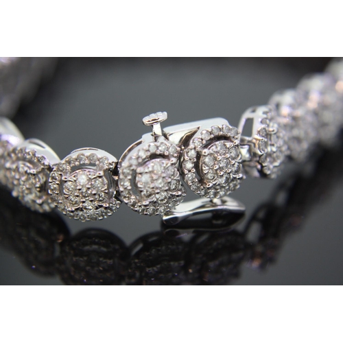 384 - 10ct white gold fancy diamond line bracelet, approx 5cts of diamonds