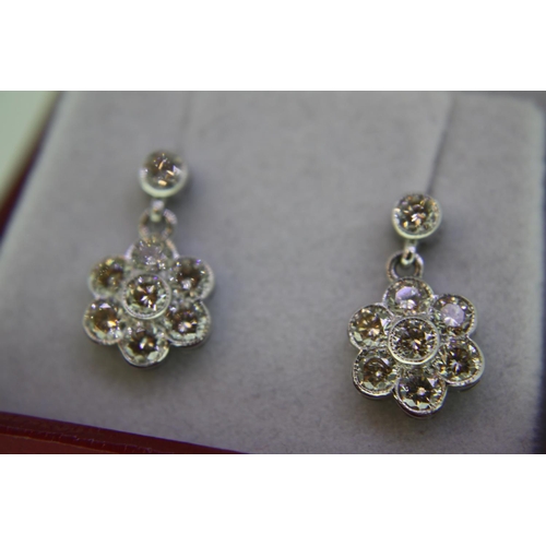 440 - Pair of 18ct white gold daisy shaped diamond cluster earrings, approx 1.5ct of diamonds