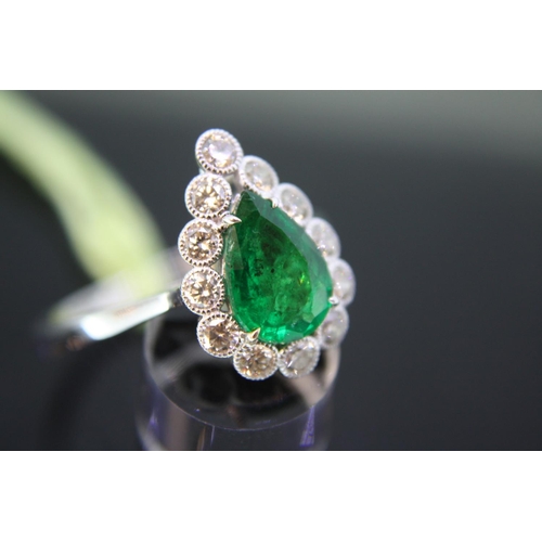 553 - 18ct white gold ring set with pear shaped emerald surrounded by diamonds, emerald 1.4ct approx, size... 