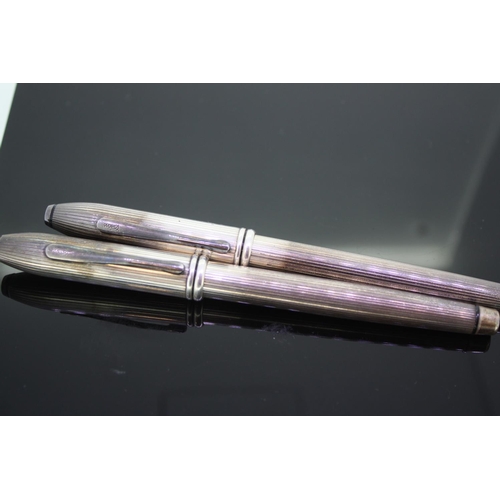 556 - Pair of Silver Cross inkpen and ball pen in a leather pouch