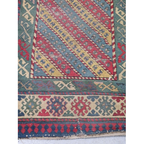 277 - Turkish style rug in multicoloured wools with geometric designs, 106x43ins