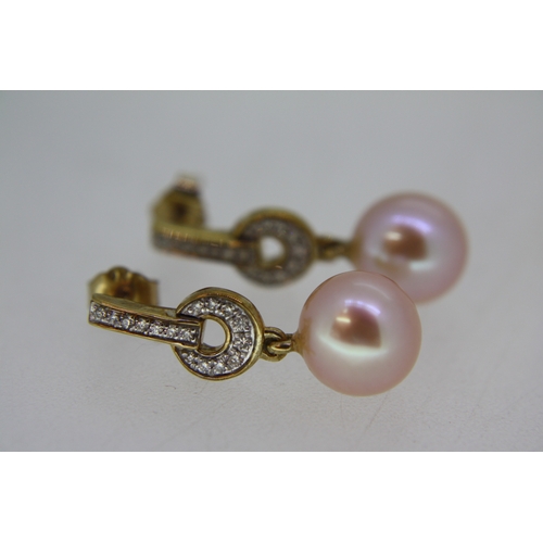 67 - Pair of 9 ct. yellow gold Art Deco style pink cultured pearl earrings with diamond set drop bales