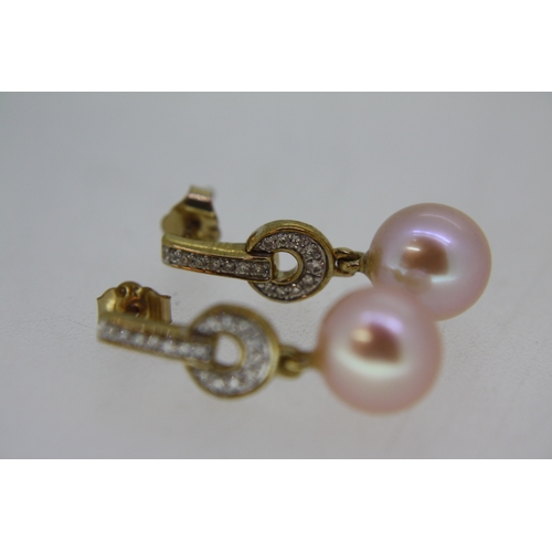 67 - Pair of 9 ct. yellow gold Art Deco style pink cultured pearl earrings with diamond set drop bales