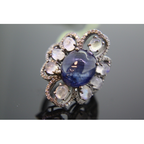 237 - Large ring set with oval cabochon blue sapphire surrounded by moonstones and diamonds set in silver,... 