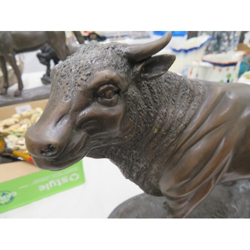 292 - A bronze brown patinated bull on a black figured marble base - length 14 ins