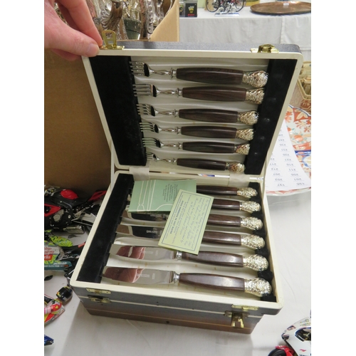 122 - Two sets of steak knives and forks, cased, plus one