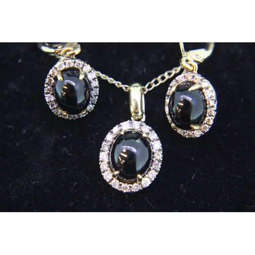 310 - 18 ct. gold cabachon oval black onyx with diamond surrounds necklace and earrings on a 9 ct. gold ch... 