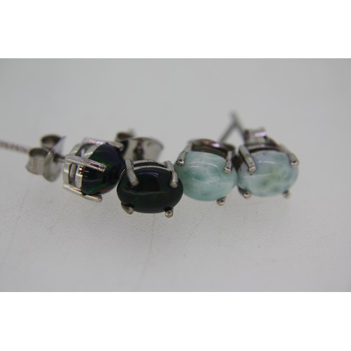 311 - Two pairs of silver ear studs set with ethopian black opal and larimar