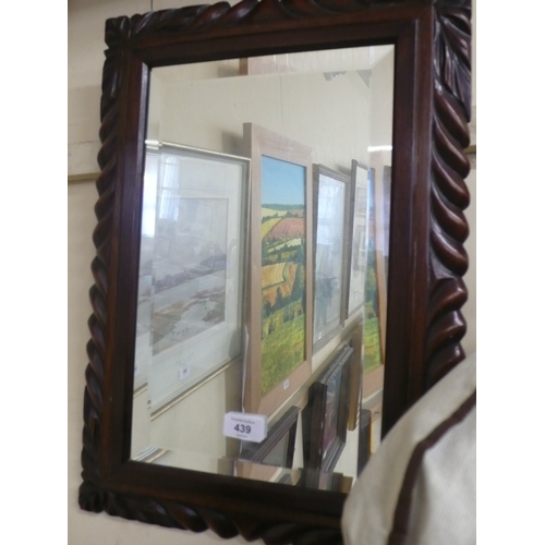 374 - Bevel edged glass wall mirror in carved wooden frame