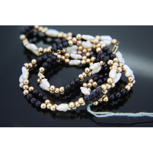 61 - 9 ct gold misshapen pearl black bead necklace