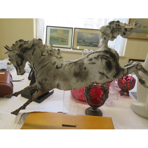 71 - A cold cast porcelain sculpture of a Horse by April Shepherd - length 20 ins approx.