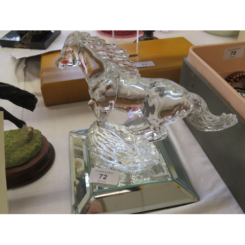 72 - A glass sculpture of a horse galloping on a mirrored base - length 7 ins approx.