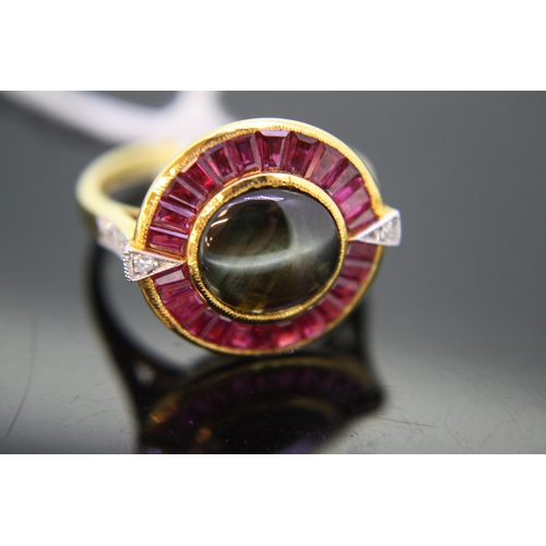 232 - 18 ct. gold target style ring set with black sapphire surrounded by rubies with diamond shoulders - ... 