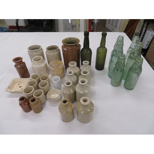 309 - A collection of old bottles and stone ink bottles and jars