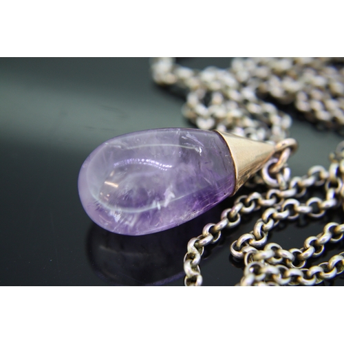 35 - Amethyst and gold coloured metal drop pendant on a silver coloured metal chain