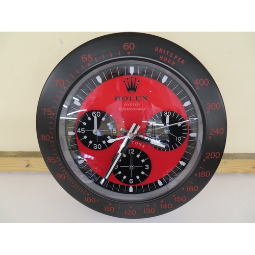 34 - Wall clock in the form of a red and black dial Rolex Daytona