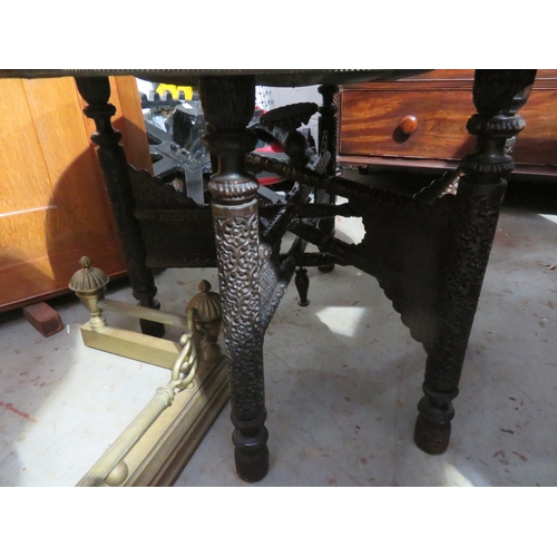 128 - Indian brass tray table with two trays to top an a well carved base