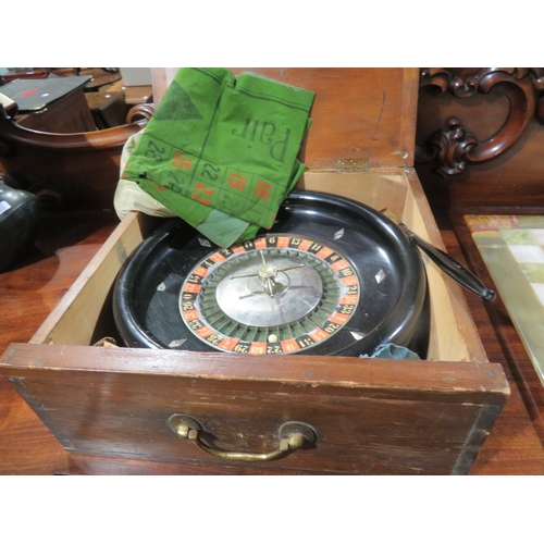 63 - Wooden cased roulette wheel together with mat, bag of pennies, etc