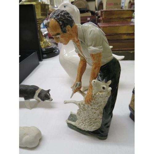 208 - Three Shebeg figures - Sheep shearer, sheep dog and white Manx cat