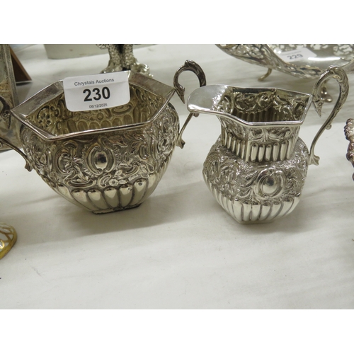 230 - A chased and half fluted silver cream jug and sugar bowl London 1891 - 4.7 ozt.