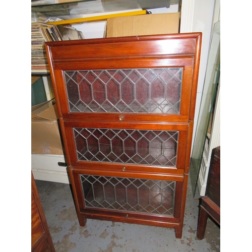 251 - Mahogany three section graduated bookcase with leaded light glass panels to front