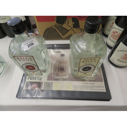 209 - Two bottles of Glen Kella Manx Whiskey 8 year old and 5 year old, plus paper cuttings